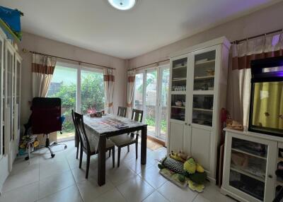 Bright dining area with large windows and garden view