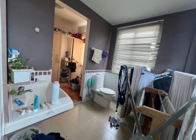 Bathroom with sink, toilet, and window blinds