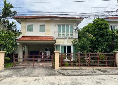 Front view of a two-story house with a gated yard