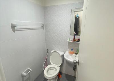 Bathroom with toilet, sink, and mirror