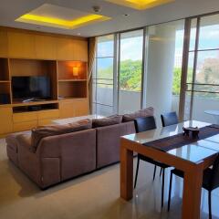 Modern living room with large windows and outdoor view