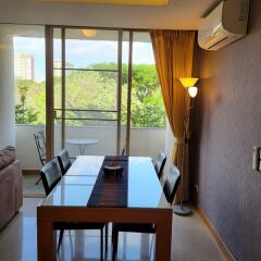 Modern dining room with table, chairs, and a view