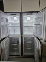 Open double-door refrigerator with empty shelves