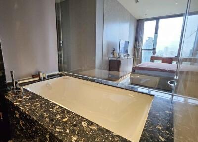 Modern bathroom with marble countertop and bathtub