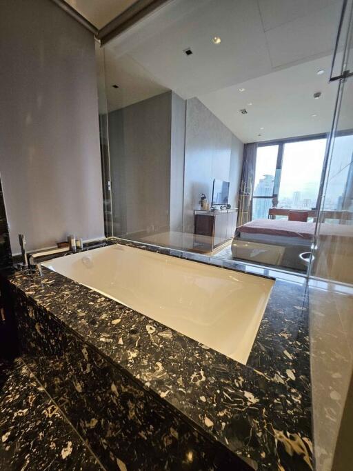 Modern bathroom with marble countertop and bathtub