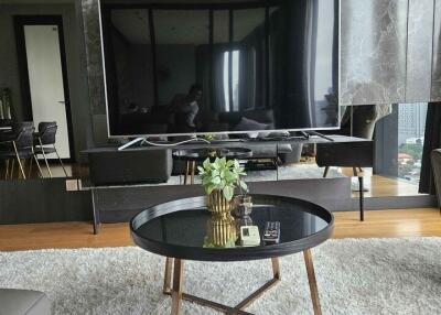 Modern living room with large TV and coffee table