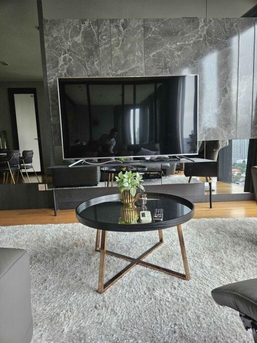 Modern living room with large TV and coffee table