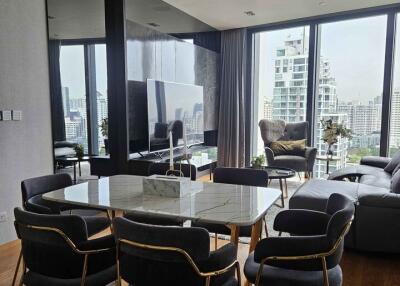 Modern living room with dining area and city view