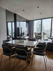 Modern living room with dining area and city view