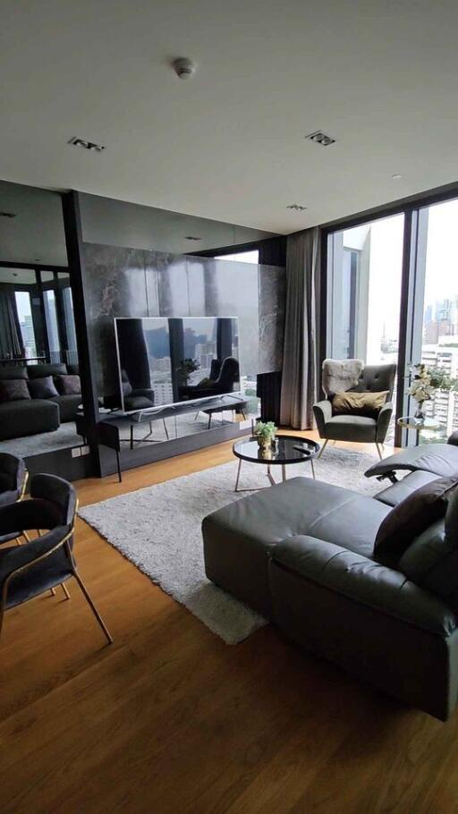 Modern living room with large TV and city view