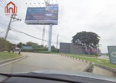 Entrance road to the property with signage and billboards