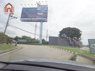 Entrance road to the property with signage and billboards