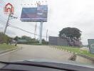 Entrance road to the property with signage and billboards