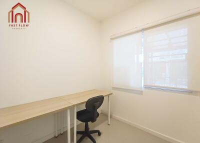 Home office with desk, chair, and window