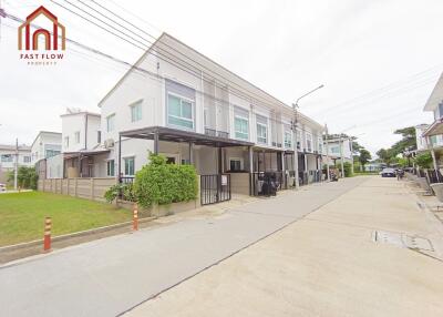 Front view of a residential building complex with attached houses