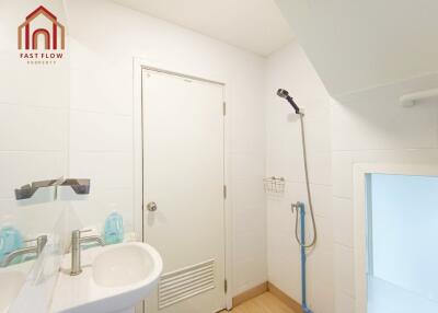 Modern bathroom with white door and shower