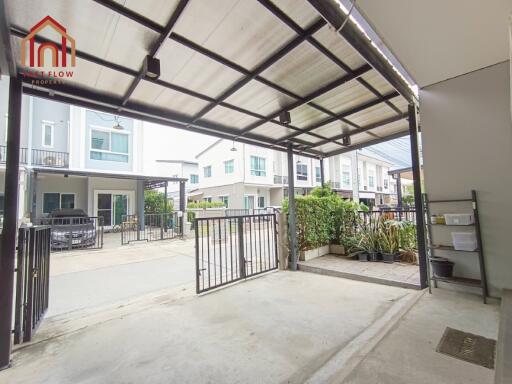 Covered carport area with gated entrance