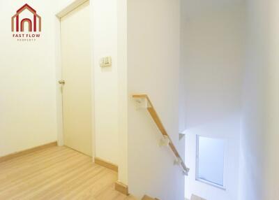 Bright staircase area with wooden flooring