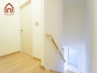 Bright staircase area with wooden flooring