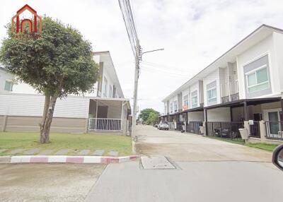 Residential buildings with driveways and green spaces