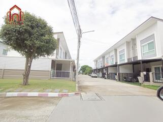 Residential buildings with driveways and green spaces