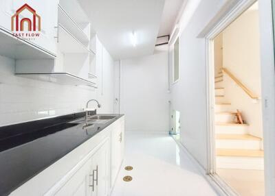 Modern white kitchen with black countertop