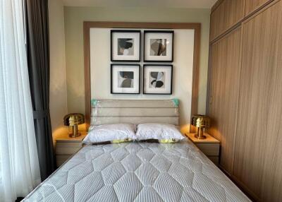 Modern bedroom with double bed, artwork, and bedside tables