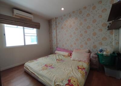 Cozy bedroom with floral wallpaper and a window