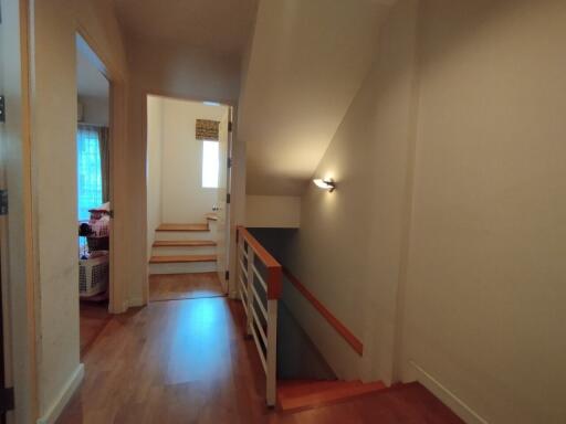 Hallway with access to upstairs rooms and staircase