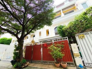 View of a building from outside with fencing and trees