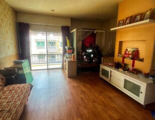 Spacious living room with large window and balcony access