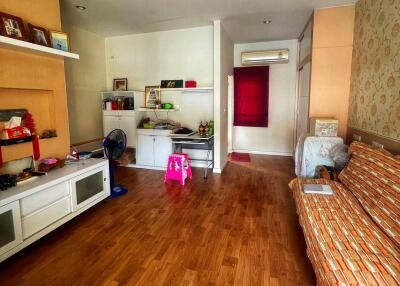 Spacious living room with wooden flooring and various furniture