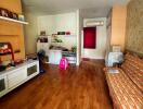 Spacious living room with wooden flooring and various furniture