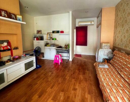 Spacious living room with wooden flooring and various furniture