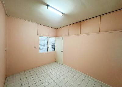 Empty bedroom with tile flooring and a window