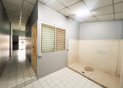 Hallway with tiled flooring and open space