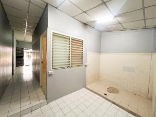 Hallway with tiled flooring and open space