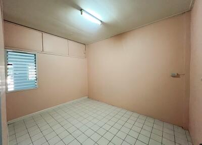 Empty room with light pink walls and tiled floor