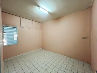 Empty room with light pink walls and tiled floor