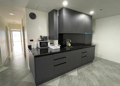 Modern kitchen with black cabinetry and appliances