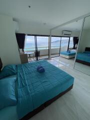 Modern bedroom with large window and ocean view