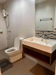 Modern bathroom with sink, toilet, and shower