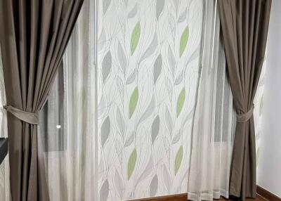 Living room with air conditioner, curtains, and hardwood floor