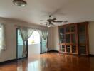 Spacious living room with wooden flooring and glass door cabinet