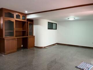 Spacious living room with built-in wooden cabinets