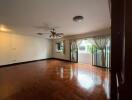 Spacious living room with wooden flooring and ample natural light