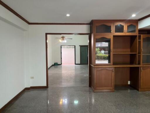 Spacious living area with wooden cabinetry and open floor plan