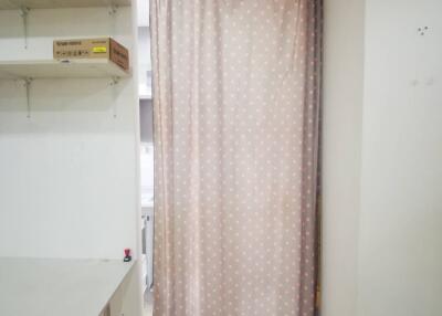 Curtained storage area with shelves and table