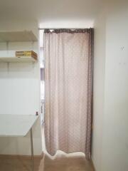 Curtained storage area with shelves and table