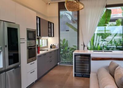 Modern kitchen with appliances and large windows